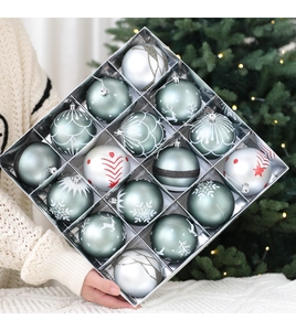 Close-up of hand holding a gift box with 16 teal and silver patterned Christmas ornaments