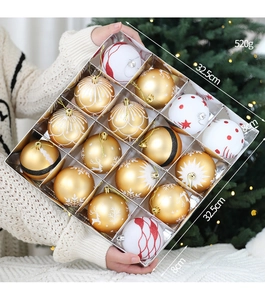 Detailed view of 16 gold and white Christmas balls in a gift box with festive patterns