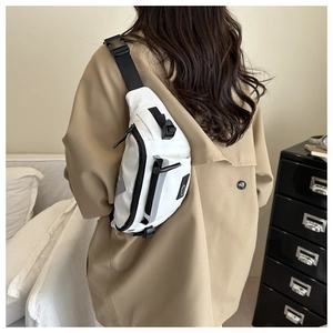 Model view of black and white sports chest bag with adjustable strap and dual zippers