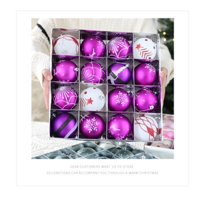 Detailed view of 16 purple and white Christmas balls with snowflake and elk patterns