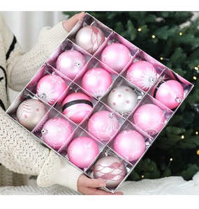 Close-up of 16 pink and champagne Christmas balls with snowflake and elk patterns