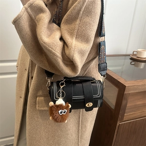 Fashionable black cylindrical crossbody bag with studded details and ethnic wide strap