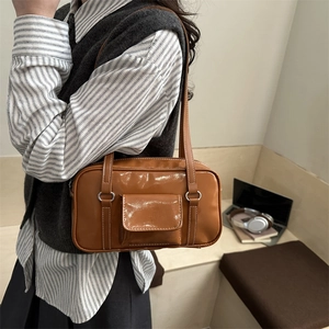 Retro brown glossy leather shoulder bag with contrast stitching for a vintage look