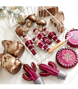 Assorted festive ornaments including nutcracker and mushroom in a metal storage basket