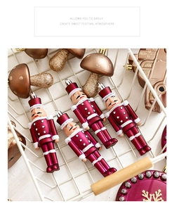 Detailed view of magenta nutcracker figurines and bronze mushroom Christmas tree ornaments