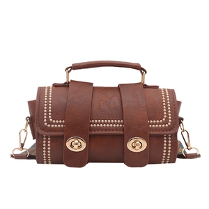 Brown vintage faux leather crossbody bag with rivet details and woven strap