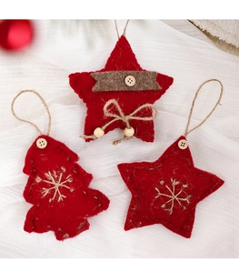 Close-up of red wool felt Christmas ornaments with star and tree shapes and wooden buttons