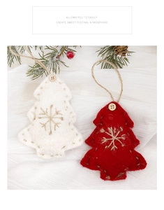 Detail of Christmas felt tree ornaments with snowflake embroidery and wooden buttons