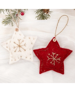 Detail of red and white wool felt star Christmas ornaments with rustic snowflake embroidery
