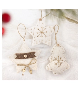 Close-up of handmade wool felt Christmas tree and star ornaments with wooden buttons