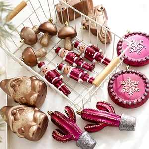 Christmas tree ornaments set featuring magenta snowflakes, nutcracker and mushroom shapes