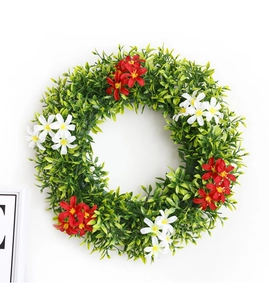 Detailed view of artificial spring wreath with green eucalyptus leaves and red white flowers
