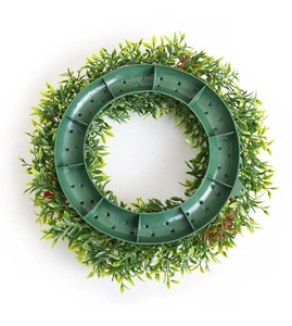 Detailed back view of a faux floral wreath showing a sturdy green plastic support frame