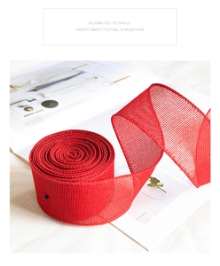 Macro shot of red faux linen mesh ribbon with woven texture for holiday decoration