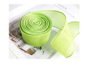Close-up of a fruit green faux linen mesh ribbon roll for festive gift wrapping