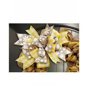 Close-up of yellow gingham and daisy ribbon bow with burlap base for door wreath decor