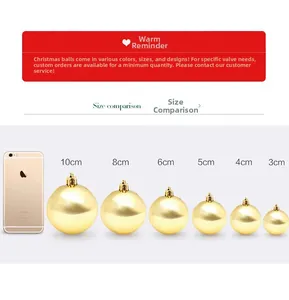 Size comparison of golden Christmas balls from 3cm to 10cm next to a smartphone