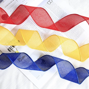 Faux linen mesh ribbons in red, yellow, and blue for DIY holiday gift decorations