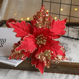 Roter Weihnachtsstern aus Stoff mit goldenen Glitzerdetails auf den Blütenblättern