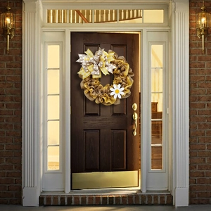 Rustic Easter bee festival burlap wreath with yellow checkered bow on a dark wood front door
