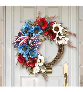 Close-up of patriotic USA flag wreath with red white blue sunflowers on a white door