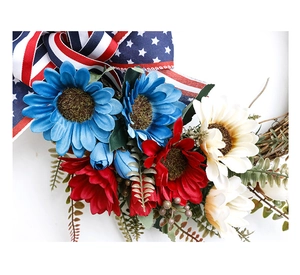 Detail of USA flag ribbon bow and sunflowers on Fourth of July patriotic wreath