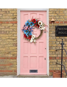 Detailed view of patriotic USA flag wreath with sunflowers on a rustic wooden door