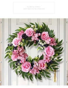 Close-up of pink rose eucalyptus wreath with berries hanging on a white wooden door
