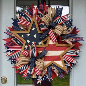 Detail of US Independence Day wreath featuring burlap bows and star frames on a front door