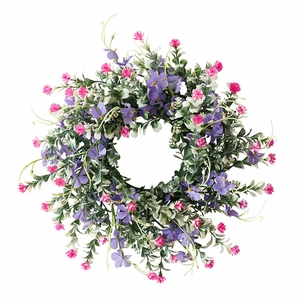 Spring artificial wreath with pink and purple wildflowers for home and garden decoration