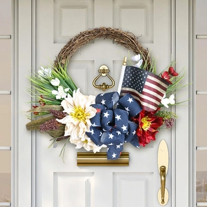Detail of July 4th patriotic wreath with US flag and stars bow on a white wooden door