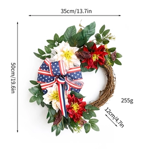 Detail of 4th of July wreath with patriotic stars and stripes bow on red dahlia flowers