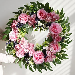 Handheld artificial pink rose and eucalyptus wreath with realistic green foliage and berries