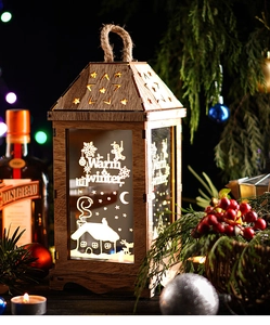 Close-up of wooden festive lantern with warm LED light and decorative holiday illustrations