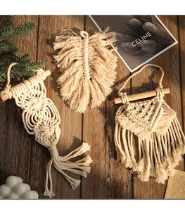 Handmade Bohemian cotton macrame leaf and tassel wall hanging decor on dark wood