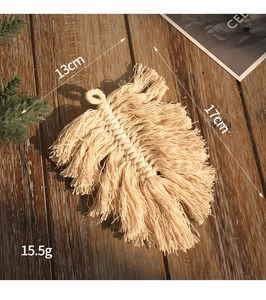 Detailed macro view of handmade macrame leaf ornament with dimensions 13cm by 17cm