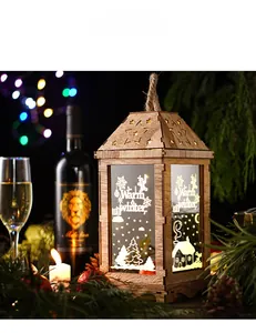Close-up of wooden Christmas lantern with LED light and winter themed scenery pattern