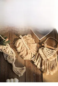 Detailed close-up of Bohemian handmade woven cotton wall hangings with tassels and wood bars