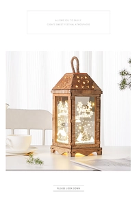 Close-up of wooden lantern featuring star cut-outs and Warm Winter scenery with LED lights
