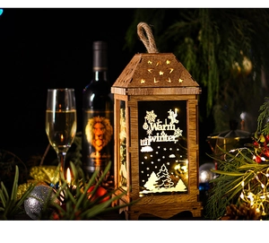 Close-up of wooden Christmas lantern with warm LED light and snowflake pattern