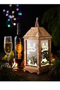 Detail of a glowing wooden Christmas lantern with Warm Winter prints and rustic rope handle