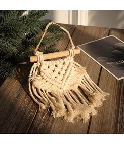 Detail of handcrafted bohemian macrame wall hanging with intricate cotton weaving and tassels