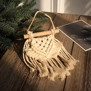Handmade Bohemian dream catcher wall hanging with cotton rope tassels on a wooden rod