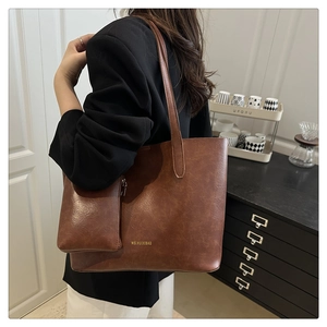 Detail of dark brown tote bag with smooth texture and hanging coin purse for commuting