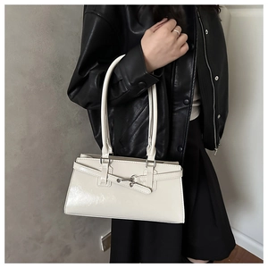 Minimalist beige glossy shoulder bag styled with a chic black leather jacket for women