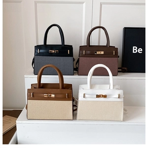 Modern trapeze handbags in four colors featuring belt buckle closure and leather accents