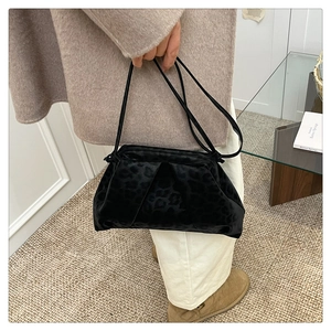 Close-up of leopard pattern velvet shoulder bag with elegant pleated cloud texture