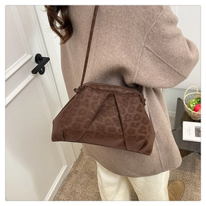 Close-up of brown leopard print ruched crossbody bag with thin adjustable shoulder strap