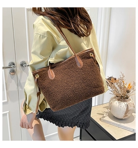 Detail showing plush faux fur texture and leather trim on a large brown tote bag