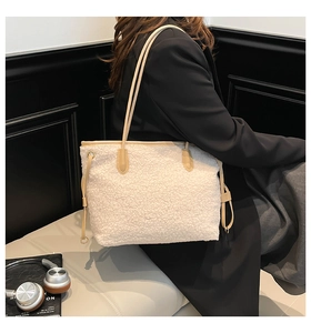 Detail of plush faux shearling tote bag with contrasting khaki leather shoulder straps